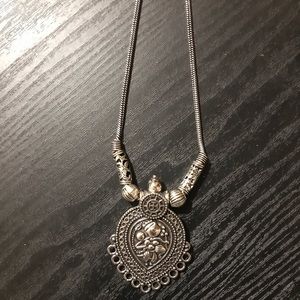 Black metal chain with attached pendant